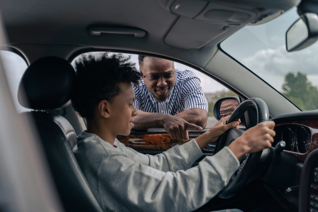 A man and two boys in the car